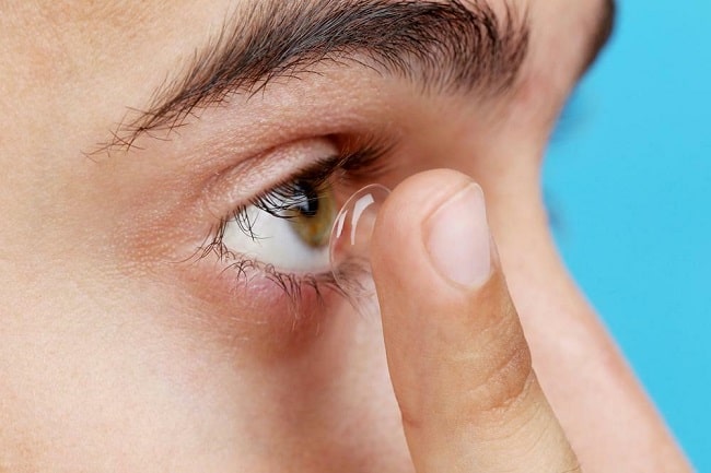 A Man applying Contact Lens